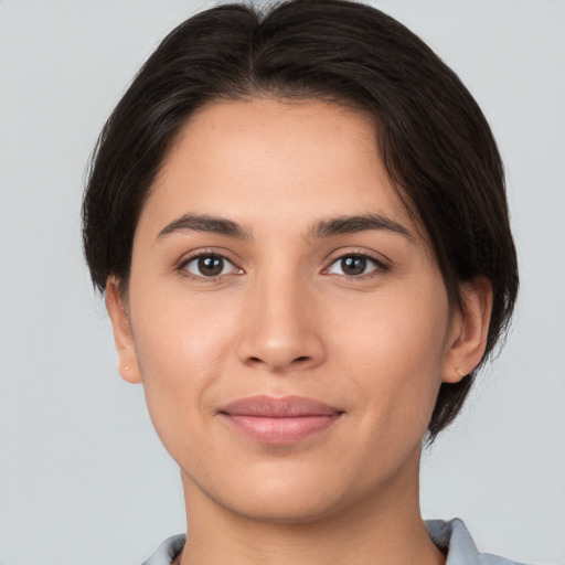 Joyful white young-adult female with short  brown hair and brown eyes