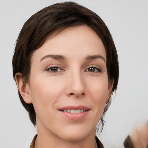 Joyful white young-adult female with medium  brown hair and grey eyes