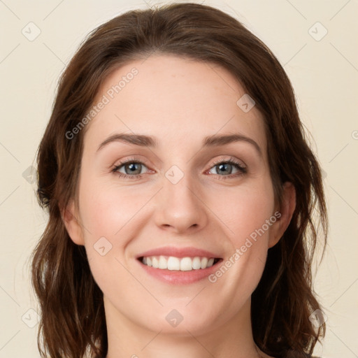 Joyful white young-adult female with long  brown hair and green eyes