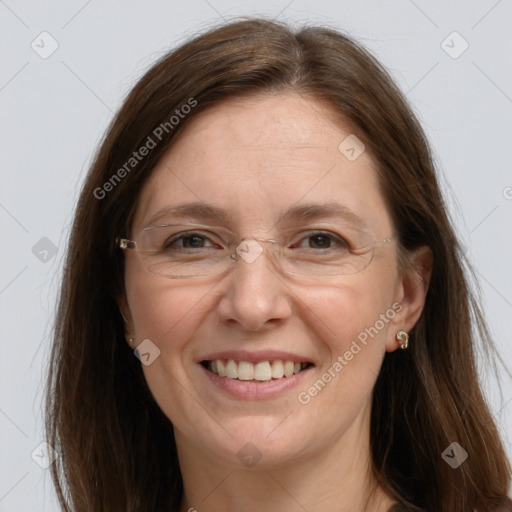 Joyful white adult female with long  brown hair and grey eyes