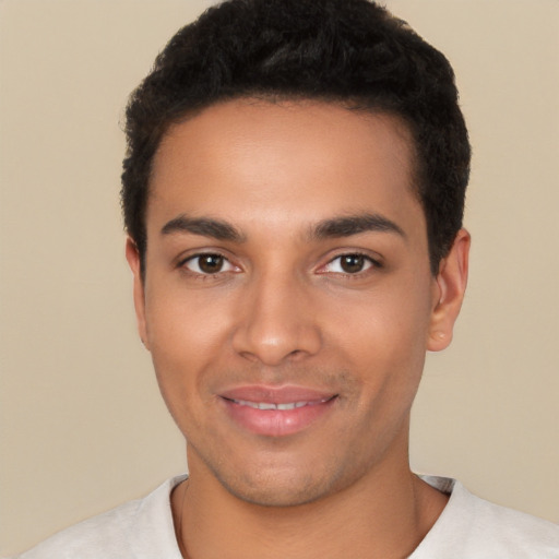 Joyful latino young-adult male with short  black hair and brown eyes