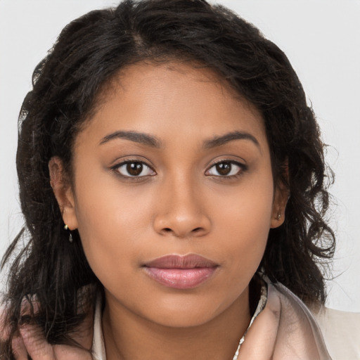 Joyful latino young-adult female with long  brown hair and brown eyes