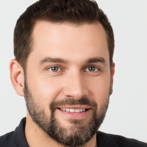 Joyful white young-adult male with short  brown hair and brown eyes