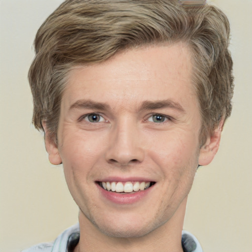 Joyful white adult male with short  brown hair and green eyes