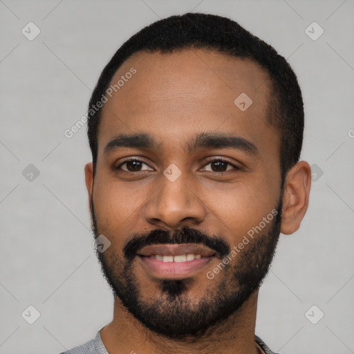 Joyful black young-adult male with short  black hair and brown eyes