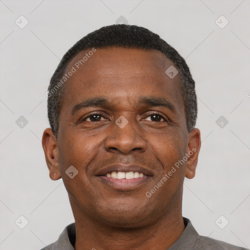 Joyful latino young-adult male with short  brown hair and brown eyes