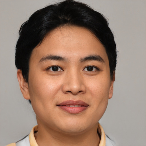 Joyful asian young-adult male with short  brown hair and brown eyes