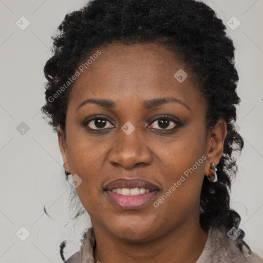 Joyful black adult female with short  black hair and brown eyes