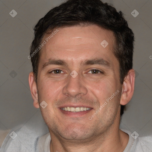 Joyful white adult male with short  brown hair and brown eyes