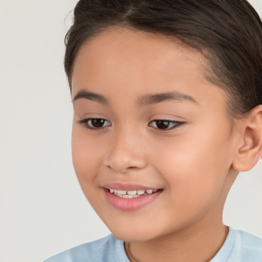 Joyful white child female with short  brown hair and brown eyes