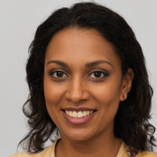 Joyful black young-adult female with medium  brown hair and brown eyes