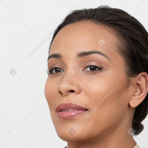 Joyful latino young-adult female with medium  brown hair and brown eyes