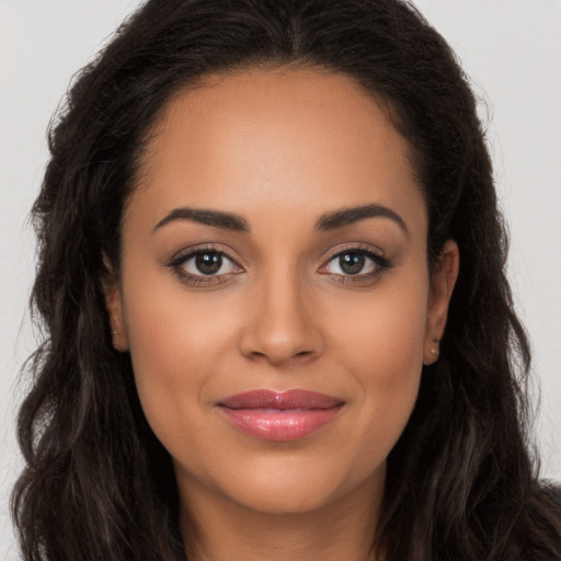 Joyful latino young-adult female with long  brown hair and brown eyes