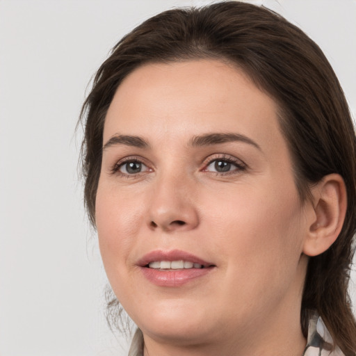 Joyful white young-adult female with medium  brown hair and grey eyes