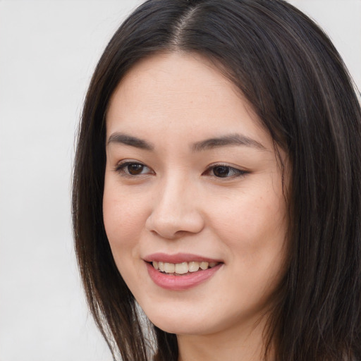 Joyful asian young-adult female with long  brown hair and brown eyes