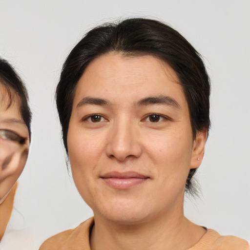 Joyful asian adult female with medium  brown hair and brown eyes