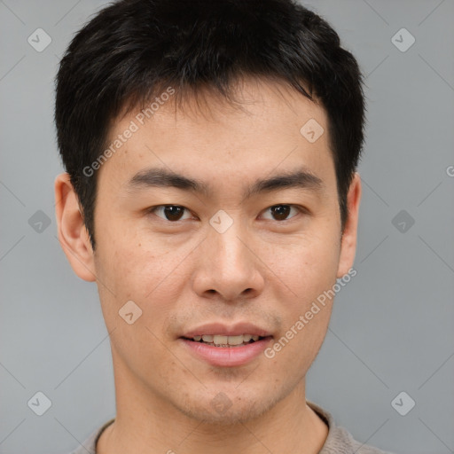 Joyful asian young-adult male with short  brown hair and brown eyes