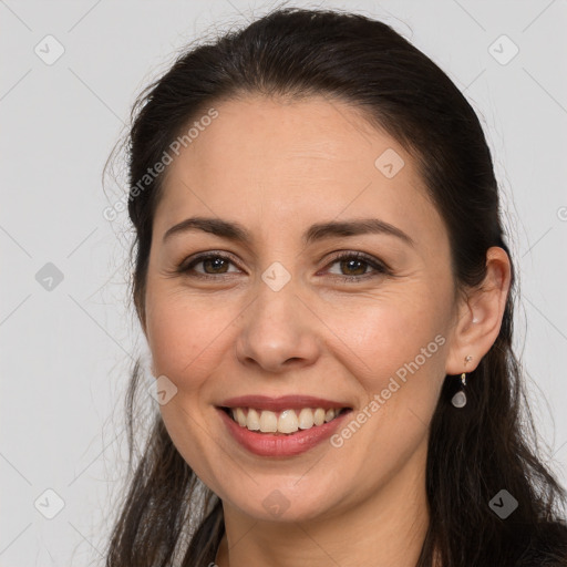 Joyful white young-adult female with long  brown hair and brown eyes