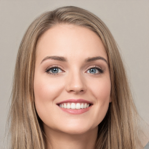 Joyful white young-adult female with long  brown hair and green eyes