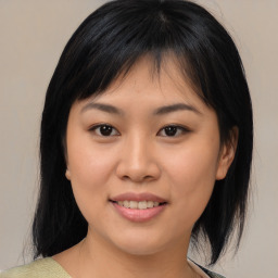 Joyful asian young-adult female with medium  black hair and brown eyes