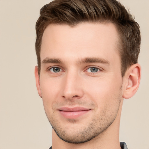 Joyful white young-adult male with short  brown hair and grey eyes