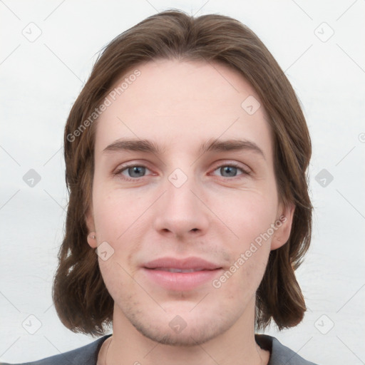 Joyful white young-adult male with medium  brown hair and grey eyes