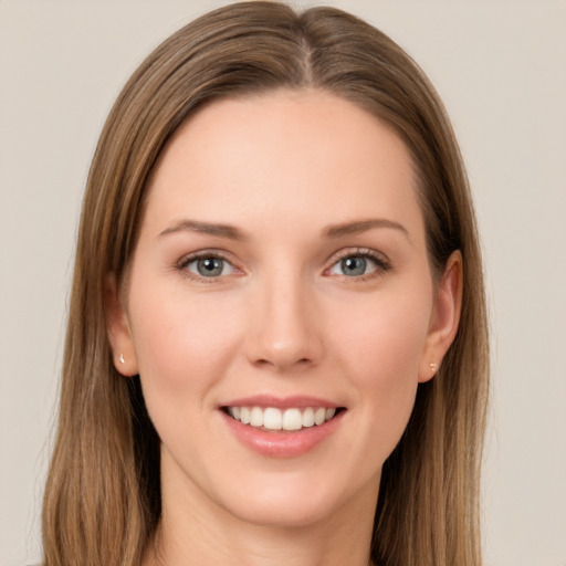 Joyful white young-adult female with long  brown hair and grey eyes