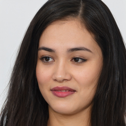 Joyful asian young-adult female with long  black hair and brown eyes