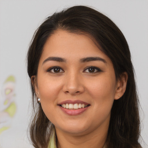 Joyful asian young-adult female with long  brown hair and brown eyes
