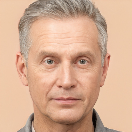 Joyful white middle-aged male with short  gray hair and brown eyes