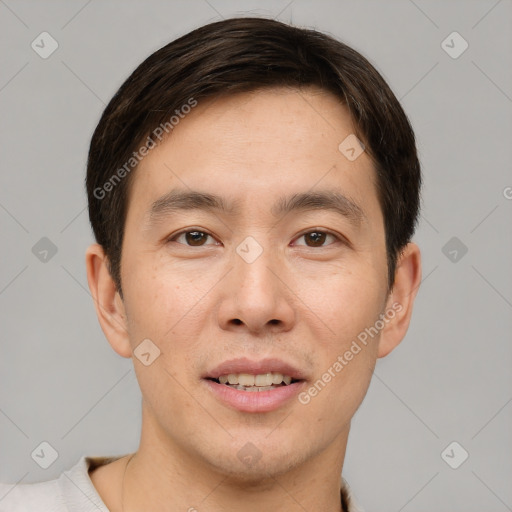 Joyful asian young-adult male with short  brown hair and brown eyes