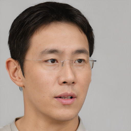 Neutral asian young-adult male with short  brown hair and brown eyes