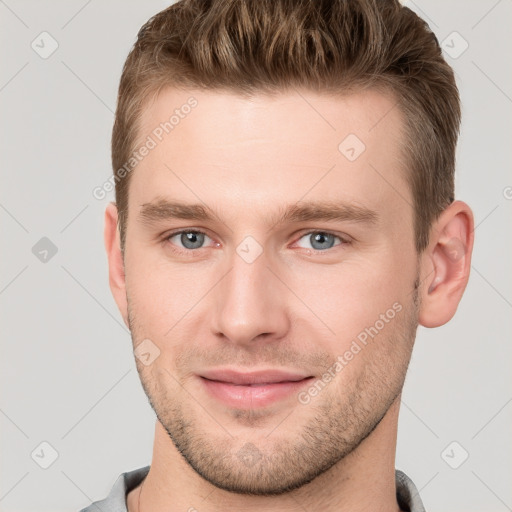 Joyful white young-adult male with short  brown hair and grey eyes