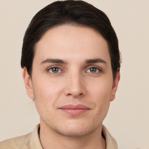 Joyful white young-adult male with short  brown hair and grey eyes