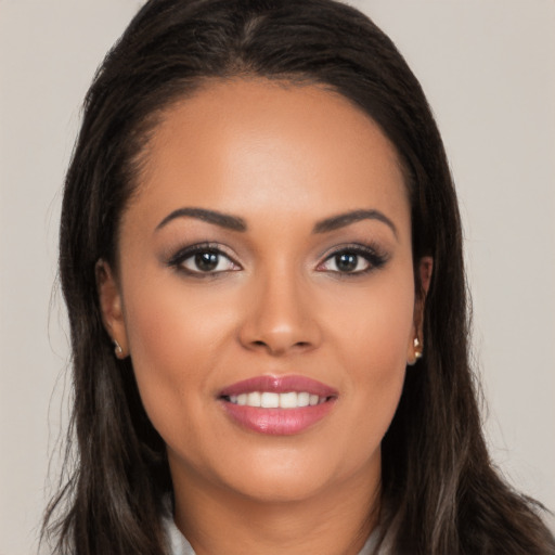 Joyful latino young-adult female with long  brown hair and brown eyes