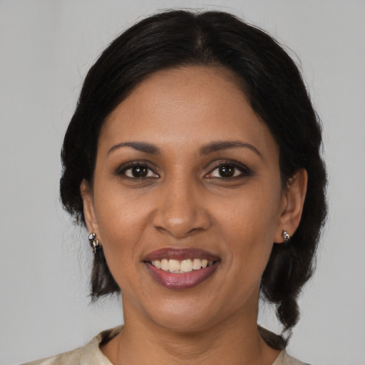 Joyful black young-adult female with medium  brown hair and brown eyes