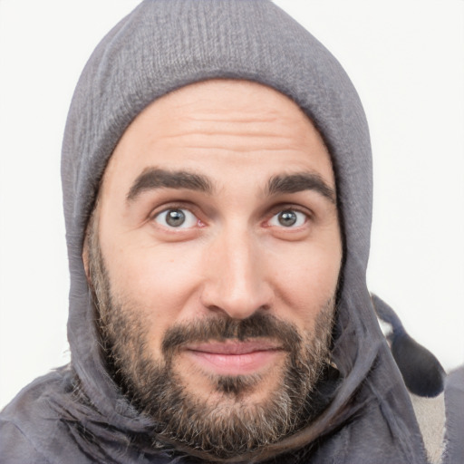 Joyful white young-adult male with short  black hair and brown eyes