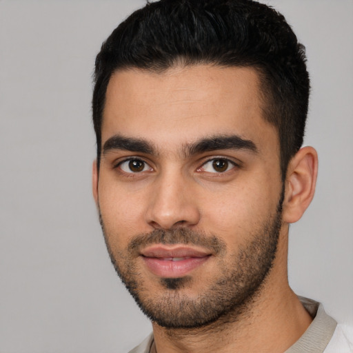 Joyful white young-adult male with short  black hair and brown eyes