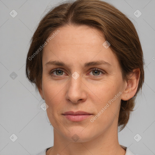 Joyful white adult female with medium  brown hair and grey eyes