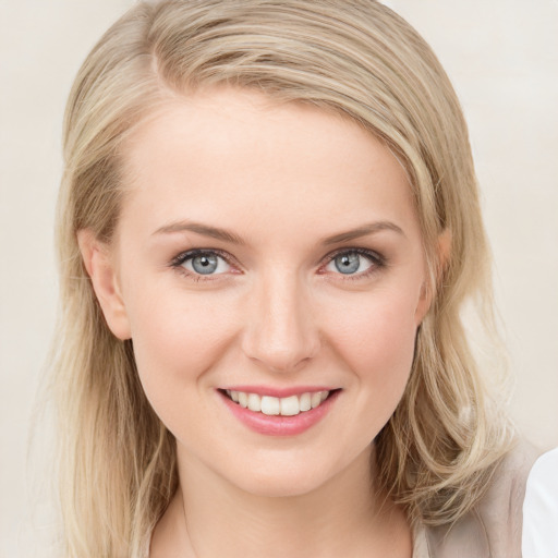 Joyful white young-adult female with medium  brown hair and blue eyes