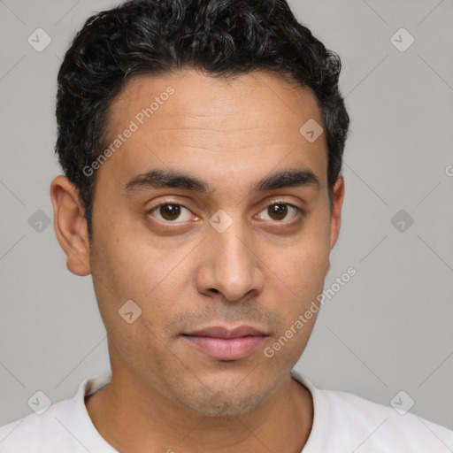 Joyful latino young-adult male with short  brown hair and brown eyes