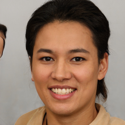 Joyful white young-adult female with short  brown hair and brown eyes