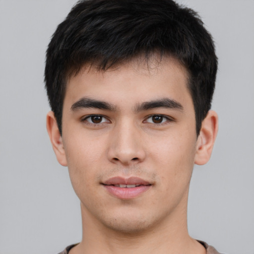 Joyful asian young-adult male with short  black hair and brown eyes