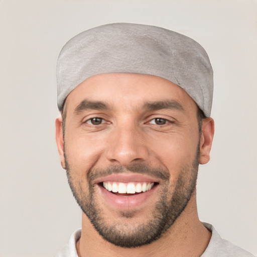 Joyful white young-adult male with short  black hair and brown eyes