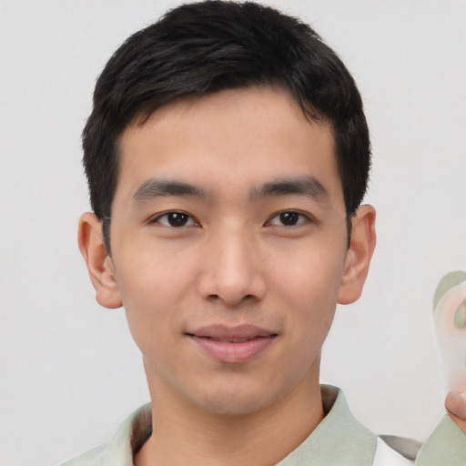 Joyful asian young-adult male with short  black hair and brown eyes