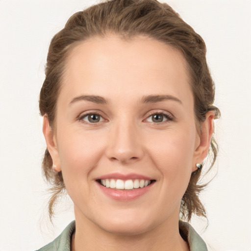 Joyful white young-adult female with medium  brown hair and grey eyes