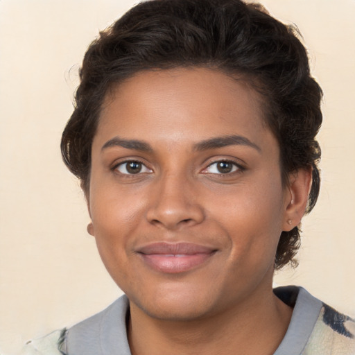 Joyful black young-adult female with medium  brown hair and brown eyes