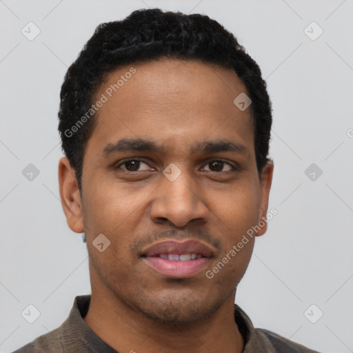 Joyful black young-adult male with short  black hair and brown eyes