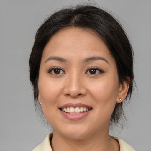 Joyful asian young-adult female with medium  brown hair and brown eyes