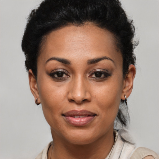 Joyful latino young-adult female with short  black hair and brown eyes